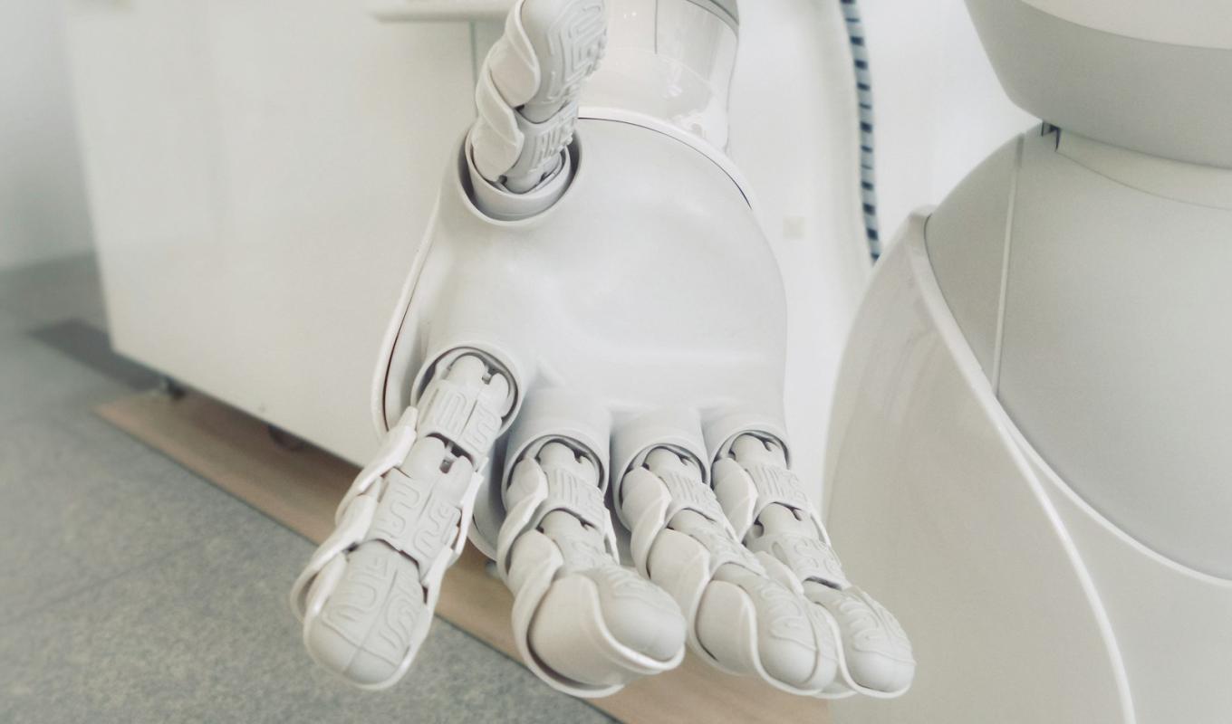 Robot hand extended — the cost of a custom AI chatbot