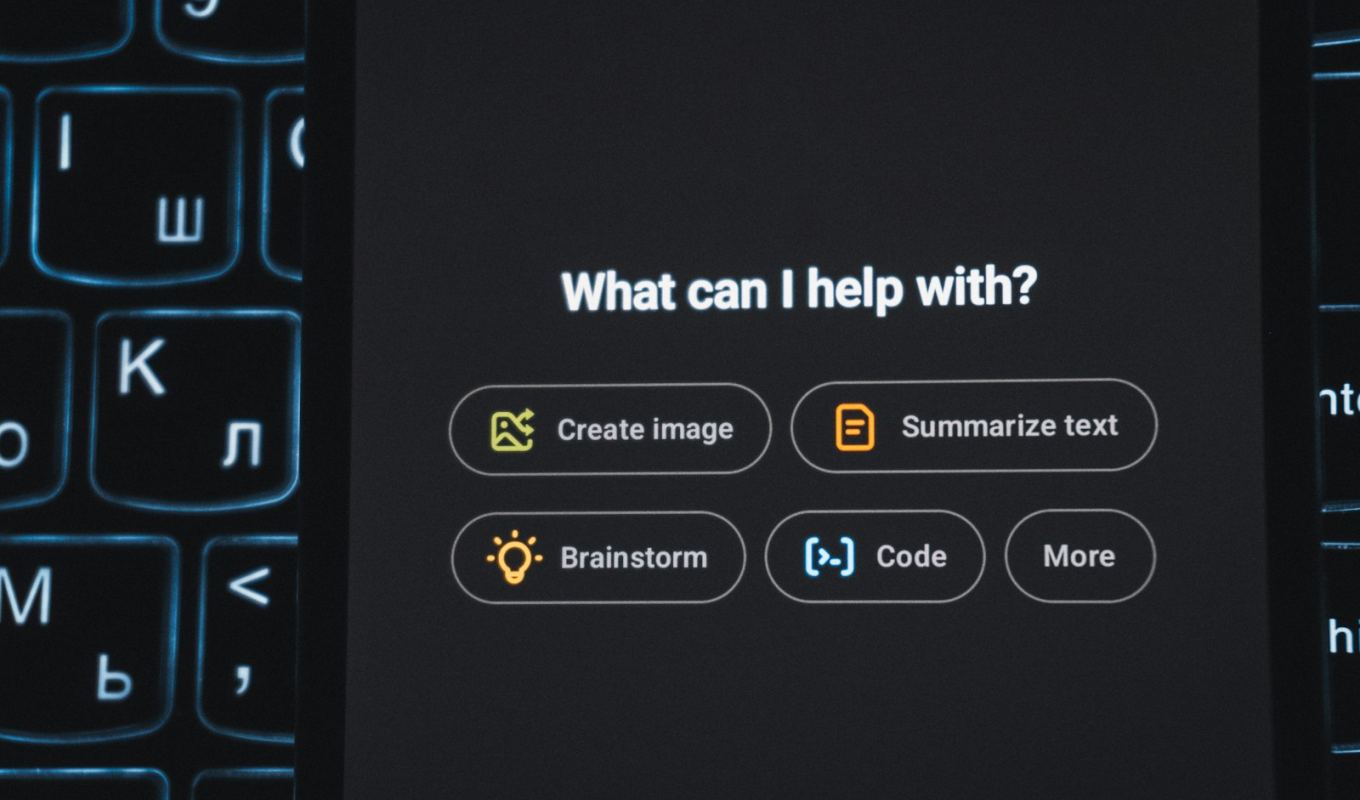 Backlit keyboard with an AI assistant interface glowing on screen