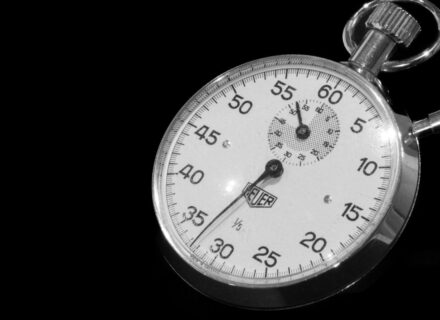 Close-up of a mechanical stopwatch against a black background