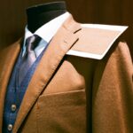 Tailored suit and fabric swatch on a mannequin - a made-to-measure build next to off-the-rack options