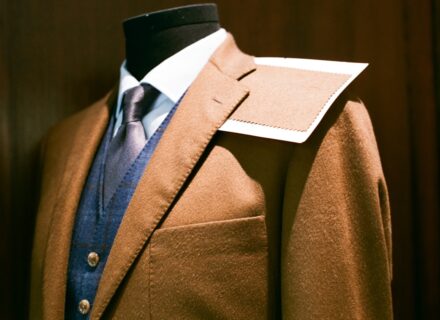 Tailored suit and fabric swatch on a mannequin - a made-to-measure build next to off-the-rack options