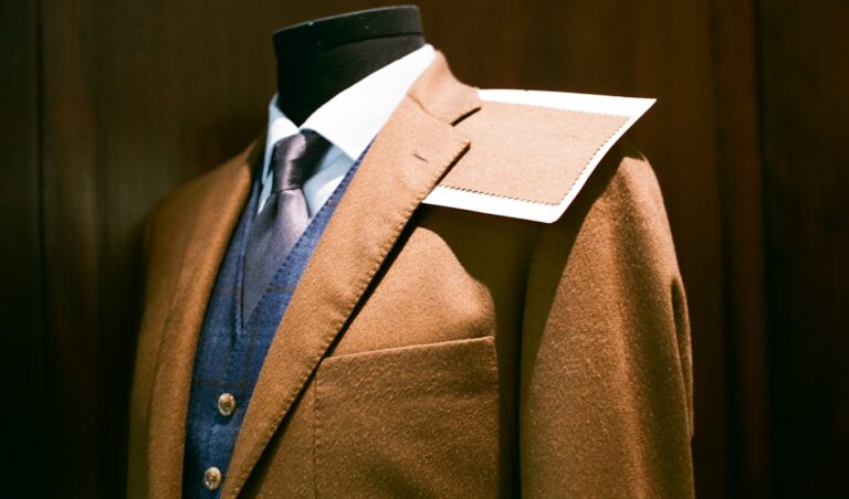 Tailored suit and fabric swatch on a mannequin - a made-to-measure build next to off-the-rack options