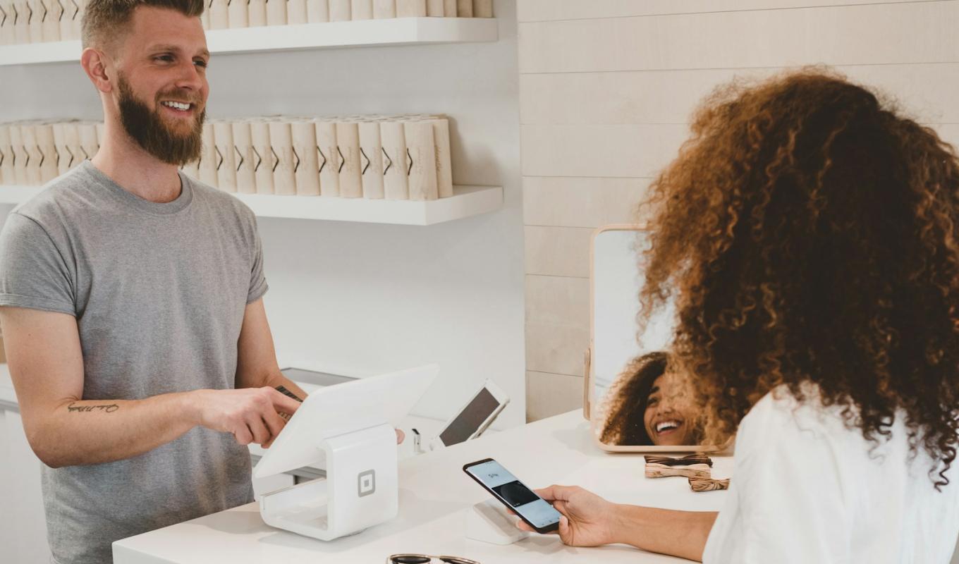 Customer paying at a store checkout — eCommerce order flow