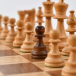 Chess pieces with one dark pawn among light ones — comparing AI models