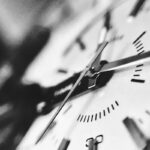 A grayscale photograph of a clock, representing billable hours
