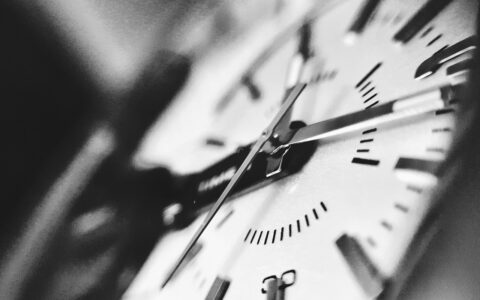 A grayscale photograph of a clock, representing billable hours