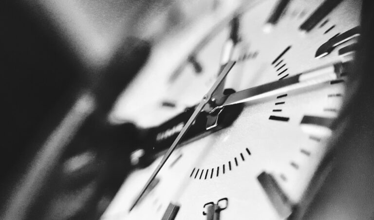 A grayscale photograph of a clock, representing billable hours