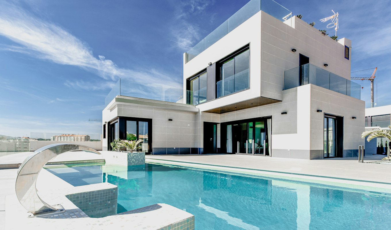 A modern white house exterior photographed against a blue sky