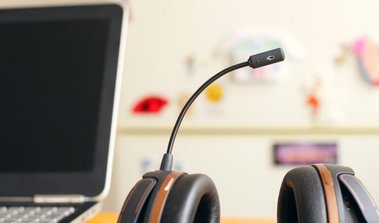 A customer support headset resting beside a laptop on a desk